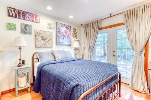 a bedroom with a bed with a blue comforter at Retreat on the Salmon River in Welches