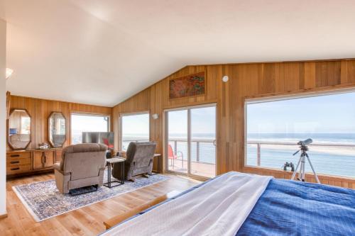a bedroom with a bed and a view of the ocean at Windsong Cove in Netarts