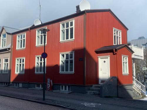 a red brick building with a red roof at Old Charm Reykjavik Apartments in Reykjavík