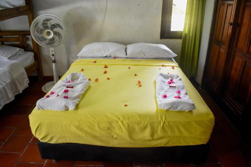 a bed that has a blanket on it at Hotel Cocotera Beach in Isla Grande