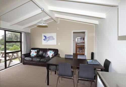 a living room with a table and a couch at Russell Top 10 Holiday Villas in Russell