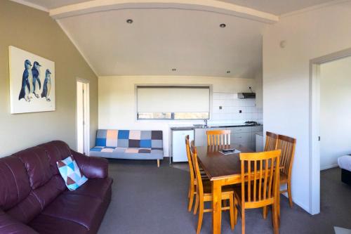 a living room with a couch and a table and chairs at Russell Top 10 Holiday Villas in Russell