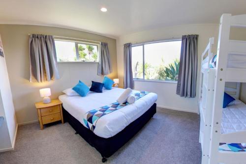 a bedroom with a bed and a bunk bed at Russell Top 10 Holiday Villas in Russell