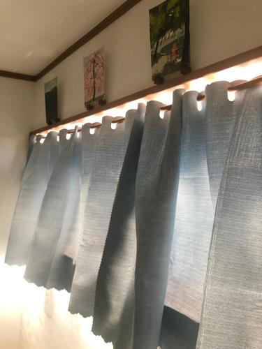 a window with white curtains in a room at Stay Nikko Guesthouse in Nikko