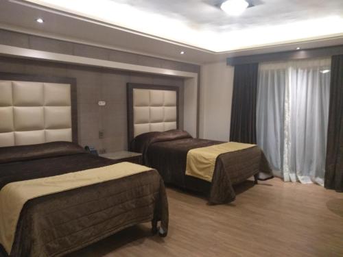 Ένα ή περισσότερα κρεβάτια σε δωμάτιο στο Hotel Jiménez Plaza
