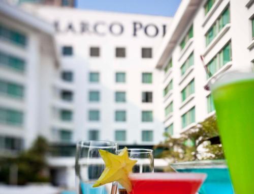 a glass with a star on a table in front of a building at Marco Polo Xiamen in Xiamen