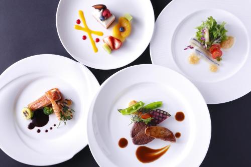 four white plates with different types of food on them at Nara Hotel in Nara