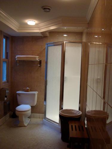 a bathroom with a toilet and a shower at Kingston Hotel in Vancouver