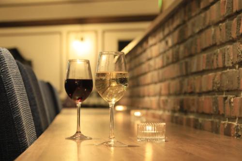 two glasses of wine sitting on a table at Yutorelo Nikko in Nikko