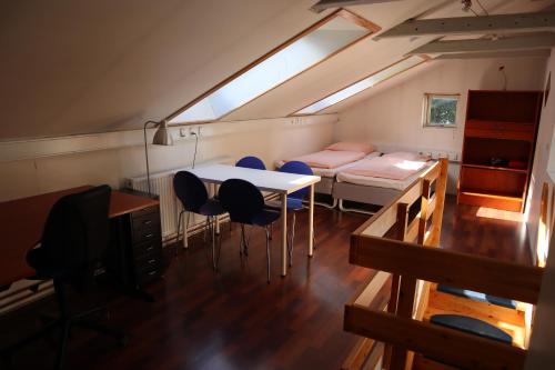 a room with a table and chairs and a bed at Rooms in quiet Yellow Courtyard Apartment in Copenhagen