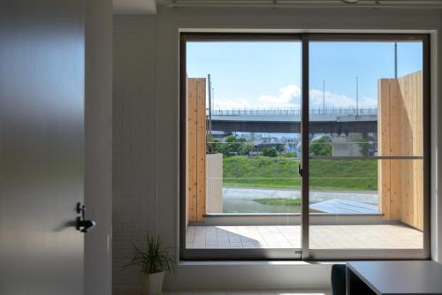 a room with a window with a view of a bridge at ゲストスイート福菊 in Kyoto
