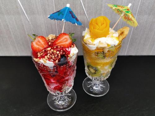 two deserts with fruit and whipped cream and an umbrella at White Rose Guest House in Filey