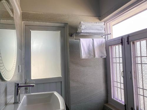 a bathroom with a sink and a mirror at Kibu Home in Kathmandu