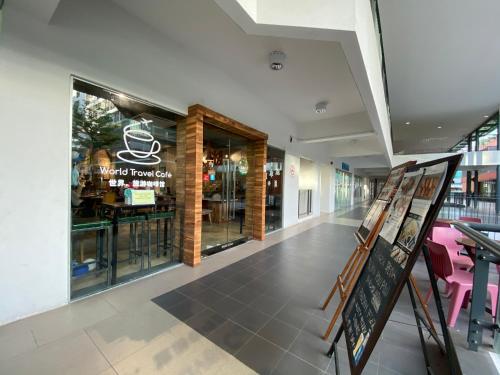 a restaurant with a sign in the middle of a building at Homesuite' Home at Aeropod SOVO in Kota Kinabalu