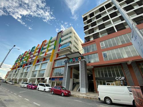a row of tall buildings on a city street at Homesuite' Home at Aeropod SOVO in Kota Kinabalu