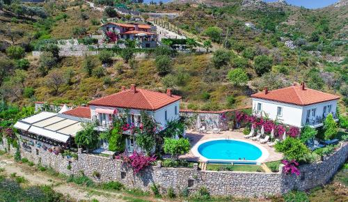 an aerial view of a house on a hill with a swimming pool at Swan Lake Hotel - Adult Only in Selimiye