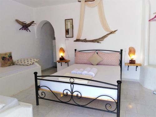 a bedroom with a bed with pink pillows on it at Errika's Sweet Home in Provatas
