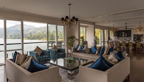 a living room with couches and blue pillows at Villa Serenity in Hatton