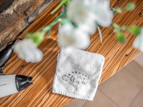 a table with flowers and a napkin on it at Villa Magnat SPA, JACUZZI, SAUNA, TĘŻNIA SOLANKOWA in Białka Tatrzanska