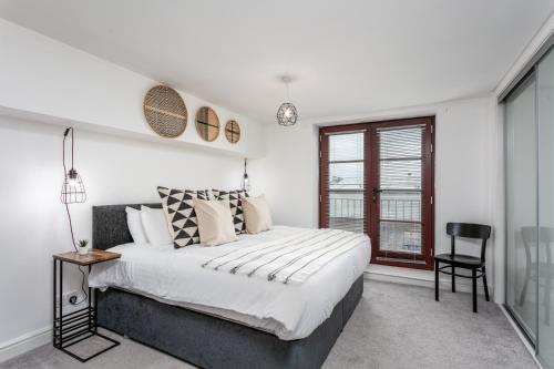 a bedroom with a large bed and a window at Granary Suite No22 - Donnini Apartments in Ayr