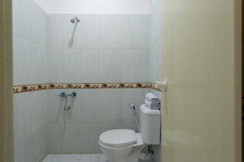 a white bathroom with a toilet and a shower at OYO 1966 Bromo Hill in Probolinggo