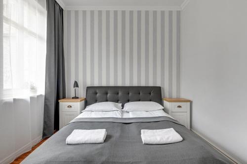 a bedroom with a large bed with two white pillows at Willa Morska Superior by Grand Apartments in Sopot