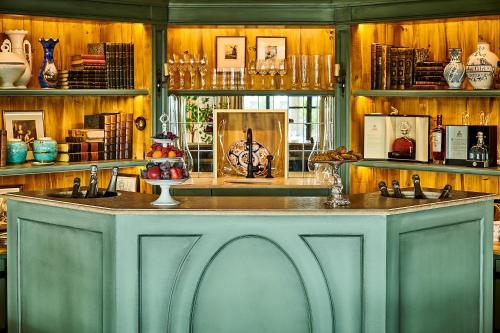 a kitchen with a counter with two sinks and shelves at Airelles Gordes, La Bastide in Gordes