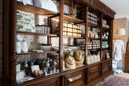 a display cabinet filled with hats and other items at Airelles Gordes, La Bastide in Gordes
