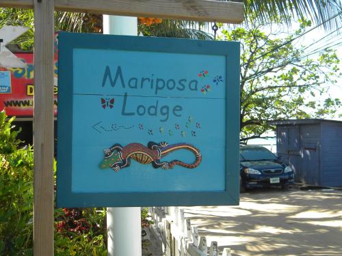 a sign for a mariposa lodge with a snake on it at Mariposa Lodge in West End