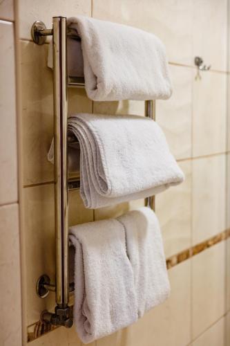 four towels on a towel rack in a bathroom at Argo in Lviv