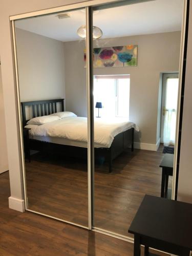 a mirror in a room with a bed and a bedroom at Beach Haven Apartments in Tramore
