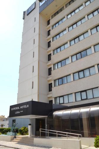 a building with a train in front of it at Hotel Eurosol Leiria & Jardim in Leiria