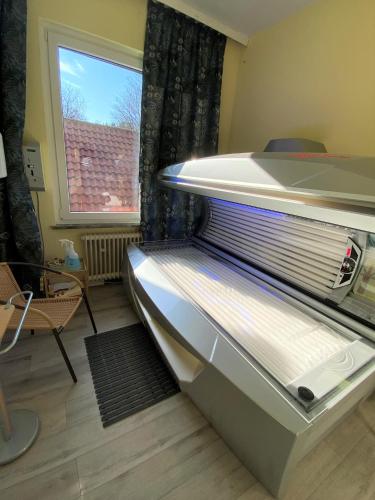 a refrigerator freezer sitting in a room with a window at Berghotel HARZ in Hahnenklee-Bockswiese