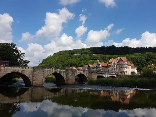 a stone bridge over a river with a town at Wohnung im Herzen der historischen Altstadt in Hannoversch Münden