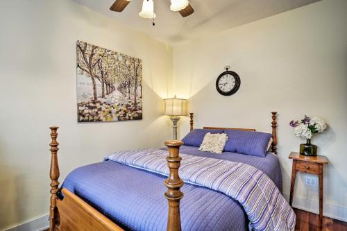 a bedroom with a bed and a clock on the wall at Northwest Michigan Duplex half Mi to Lake Michigan in Charlevoix