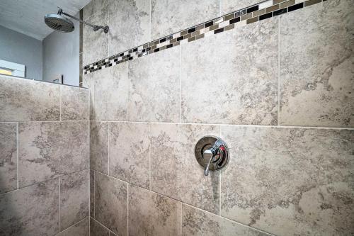 a bathroom with a shower with a stone wall at Well-equipped Cody Cottage 2 Miles to Cody Rodeo! in Cody