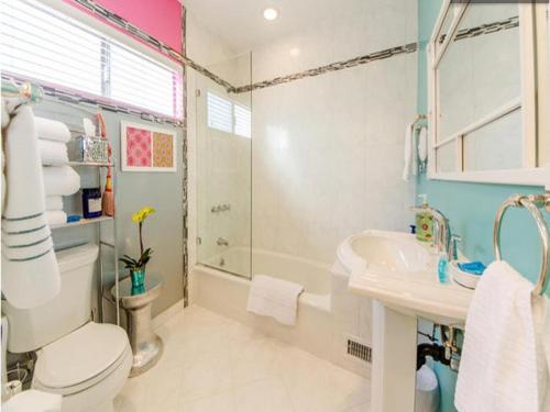 a bathroom with a toilet and a sink and a shower at Venice Beach Apartments Monthly rents in Los Angeles