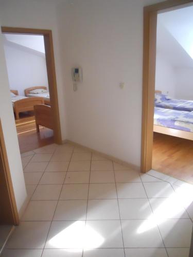 a room with a room with a bed and a mirror at Nikolic Apartments - Ohrid City Centre in Ohrid