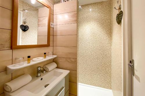 a bathroom with a sink and a shower at Hotel Le Magnan in Avignon