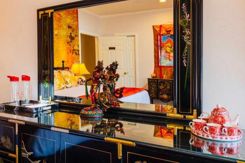 a bathroom with a mirror and a sink and a bed at Quiet Mind Mountain Lodge, Retreat & Spa in Julian