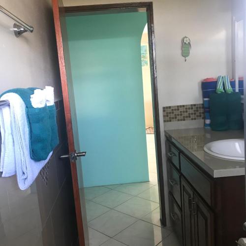 a bathroom with a toilet and a sink at Ocean View Villas in Jost Van Dyke