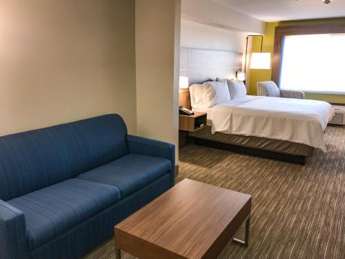 a hotel room with a bed and a couch at Holiday Inn Express & Suites Lubbock West, an IHG Hotel in Lubbock