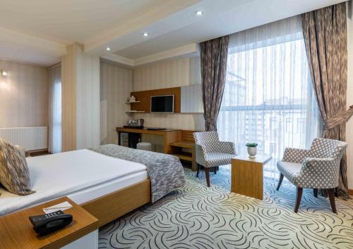 a hotel room with a bed and a desk at Dies Hotel in Diyarbakır