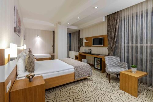a hotel room with a bed and a desk at Dies Hotel in Diyarbakır