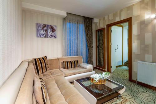 a living room with a couch and a table at Dies Hotel in Diyarbakır
