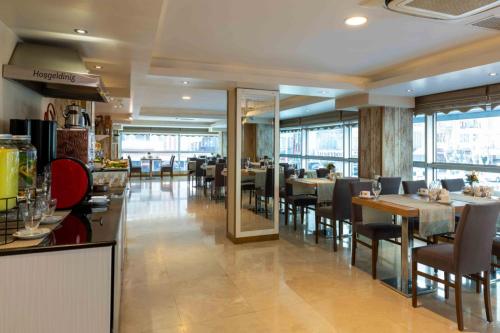 a dining room with tables and chairs in a restaurant at Dies Hotel in Diyarbakır