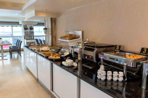 a buffet line in a restaurant with food on it at Dies Hotel in Diyarbakır