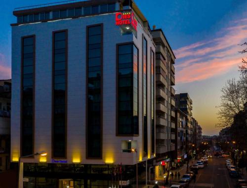 a tall white building with a hotel sign on it at Dies Hotel in Diyarbakır