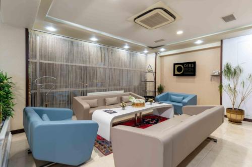 a meeting room with a table and blue chairs at Dies Hotel in Diyarbakır