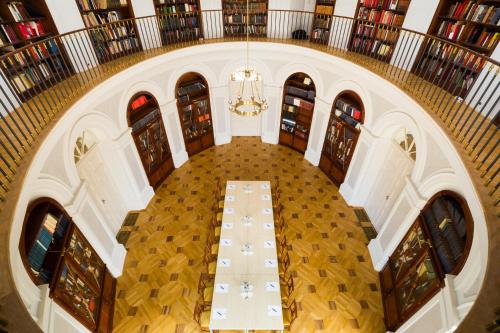 an overhead view of a hall with a table in a library at Károlyi Kastély Hotel & Restaurant in Fehérvárcsurgó